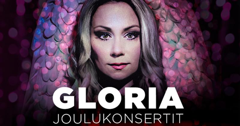 Anna Erikssonin kasvot keskellä ruutua, ne katsovat suoraan eteenpäin. Taustalla näkyy vähän abstraktit, violetit enkelin siivet. Teksti: Gloria joulukonsertit