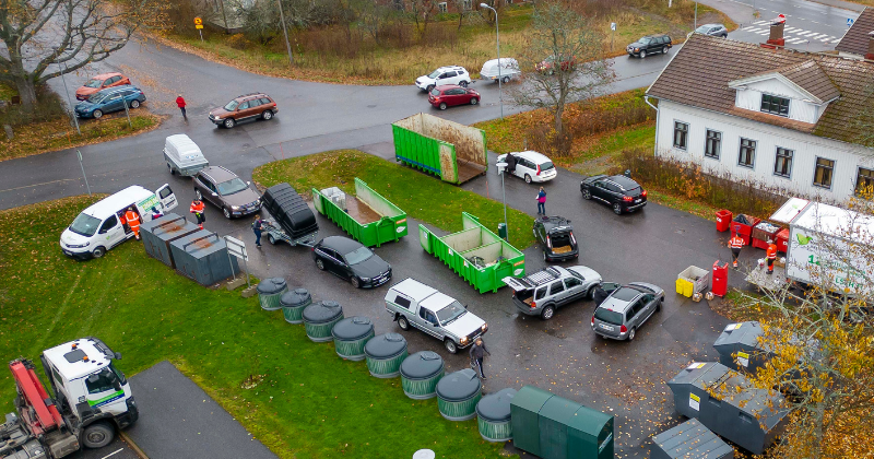 Siirreltävä jätehuoltoasema, jätteenkeräys ja -lajitteluastioita parkkipaikalla.